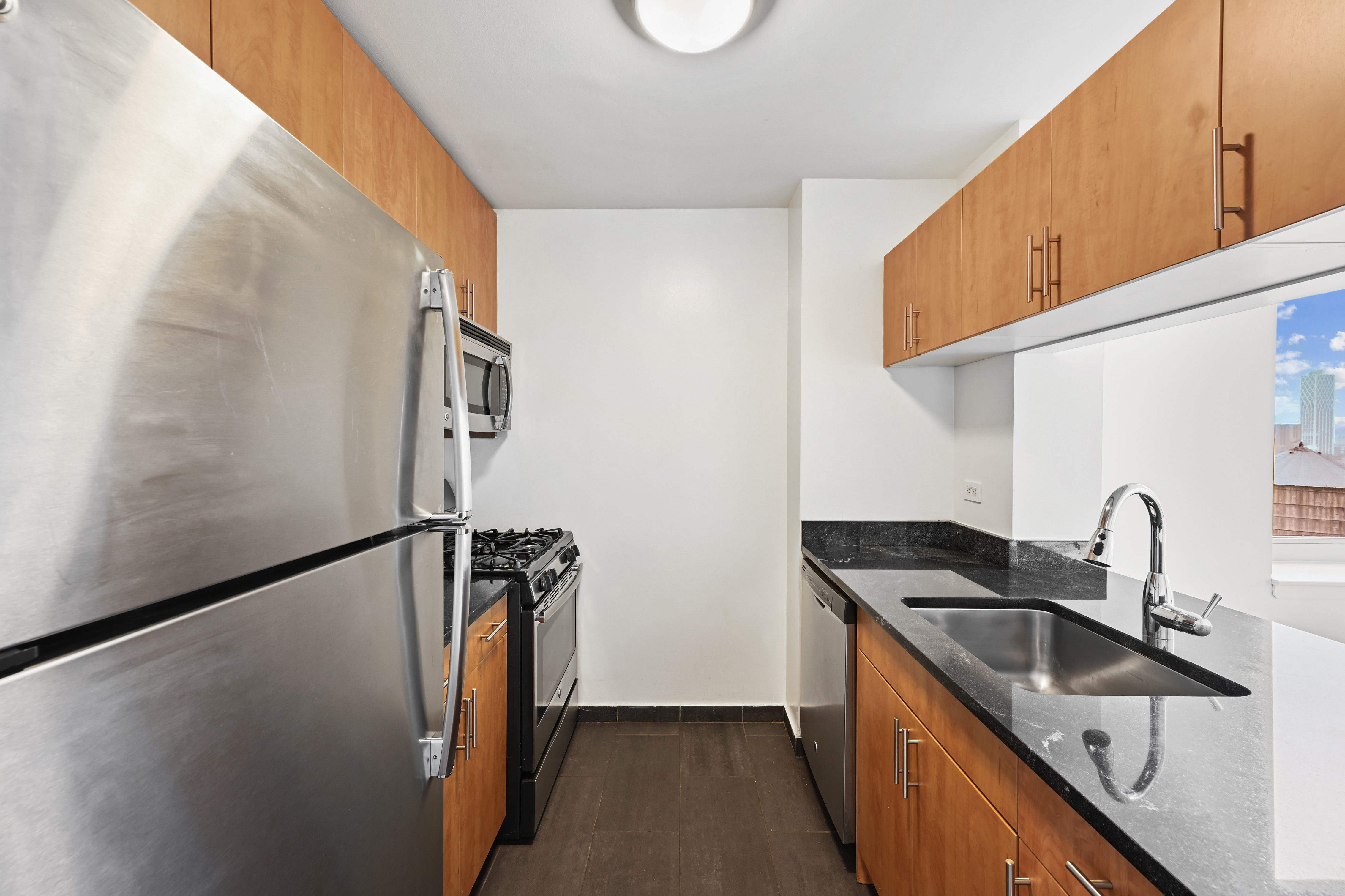 a kitchen with stainless steel appliances a sink a stove and a refrigerator