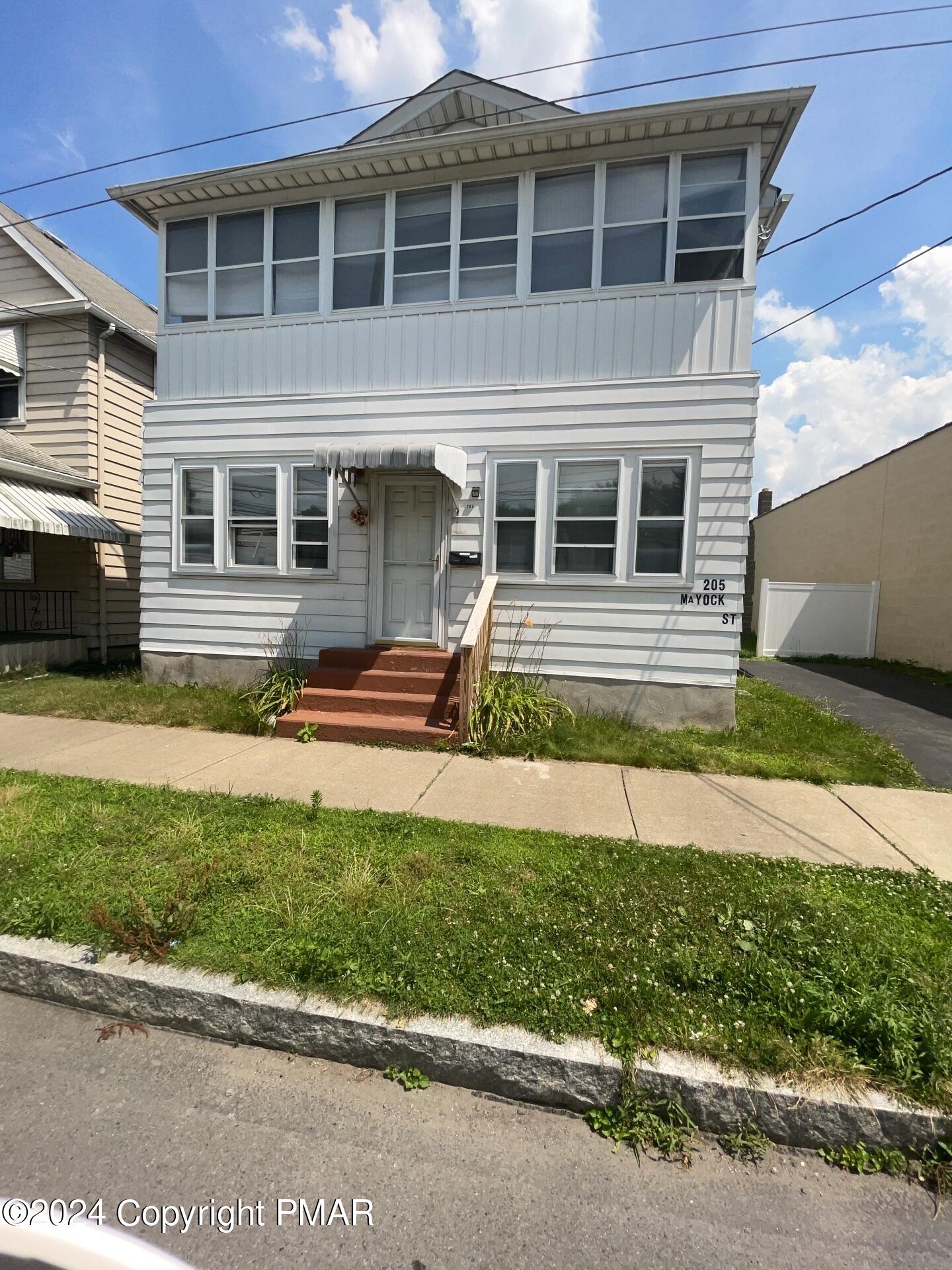 a front view of a house with a yard