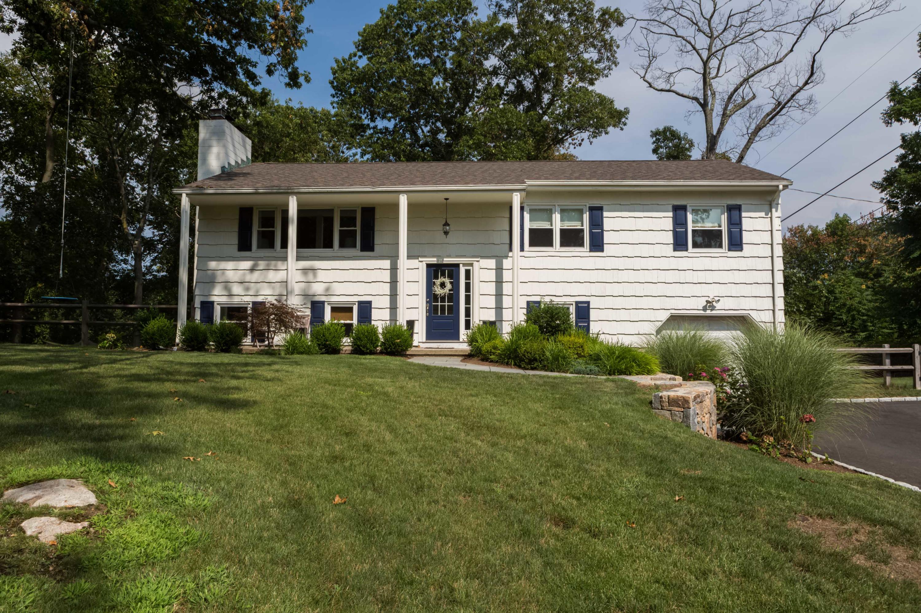 a front view of a house with a garden