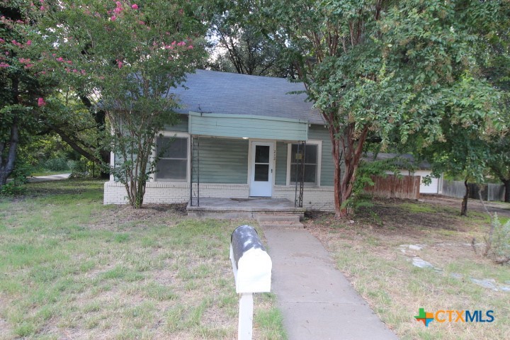 a house with trees in the background