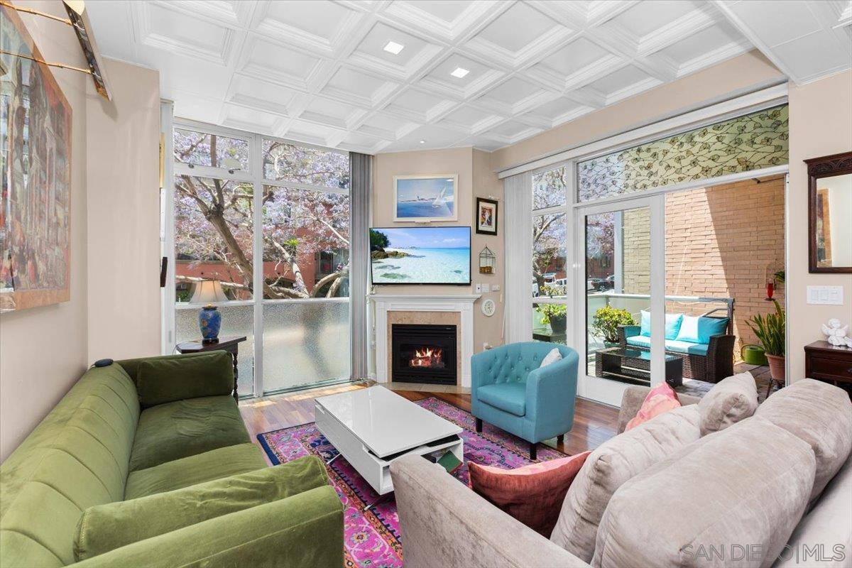 a living room with furniture a fireplace and a large window