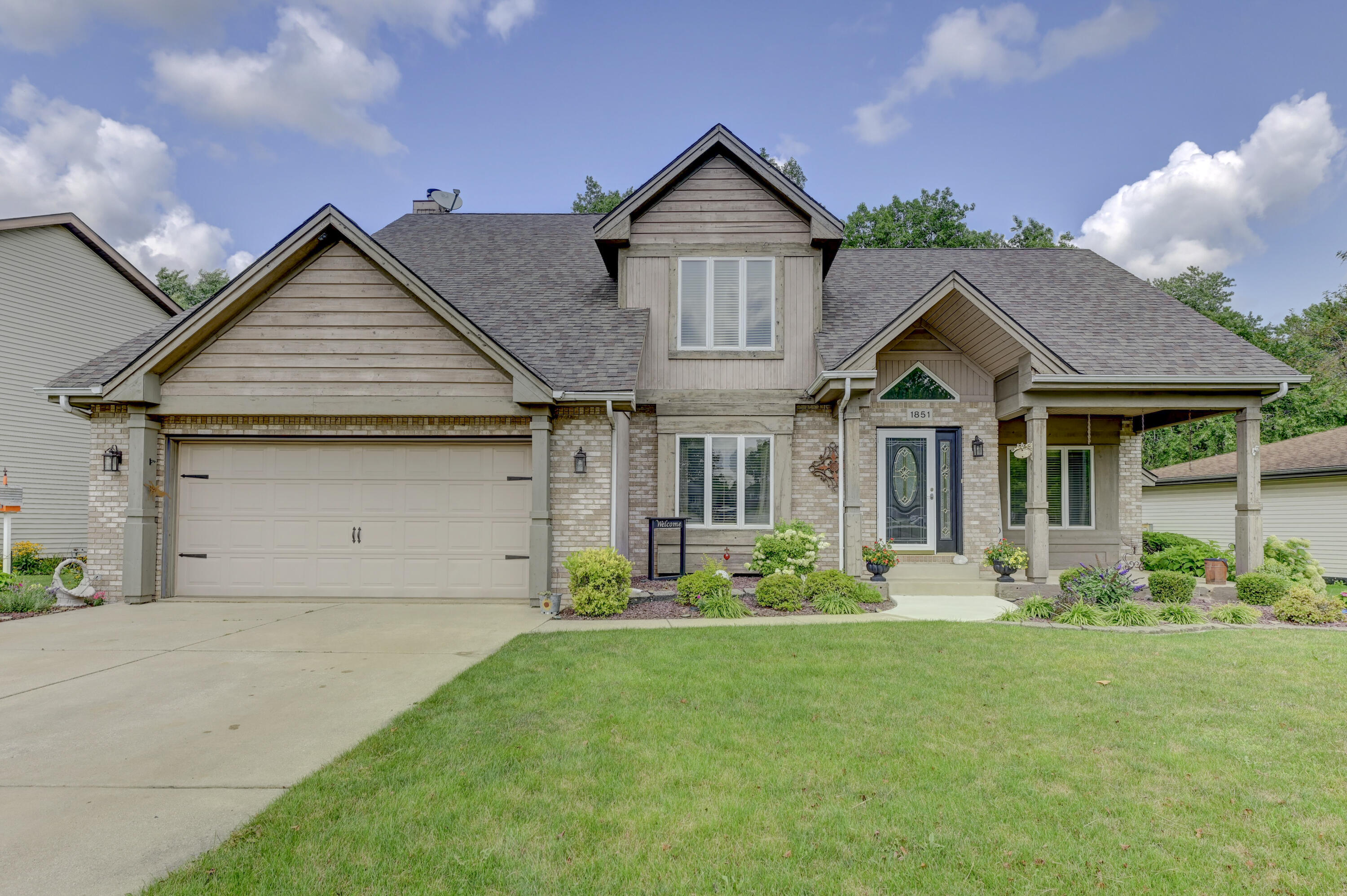 a front view of a house with a yard and porch