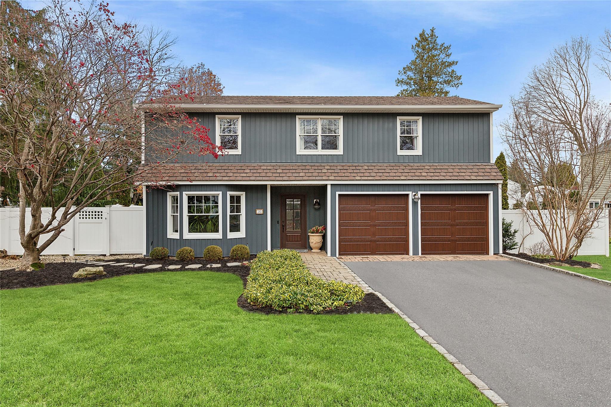 View of front property with a garage and a front yard