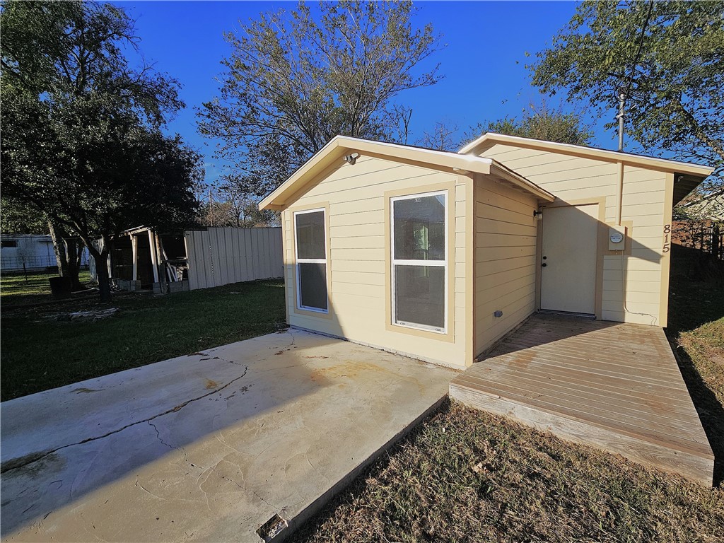 a view of backyard of house with green space