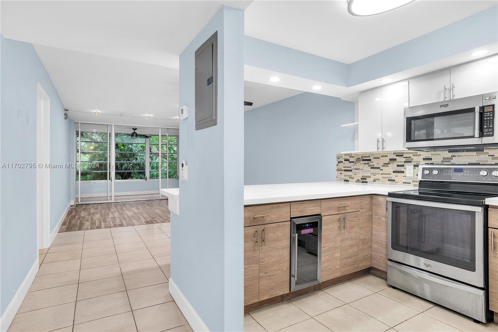 a kitchen with stainless steel appliances granite countertop a stove and a microwave