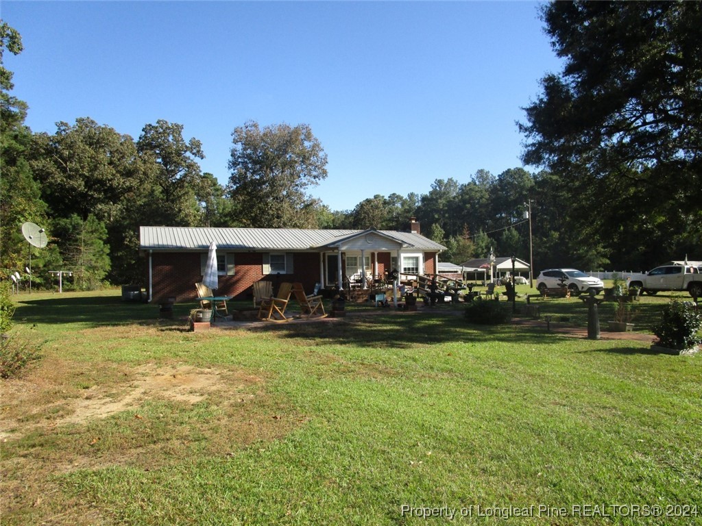 a view of a house with garden yard and sitting area