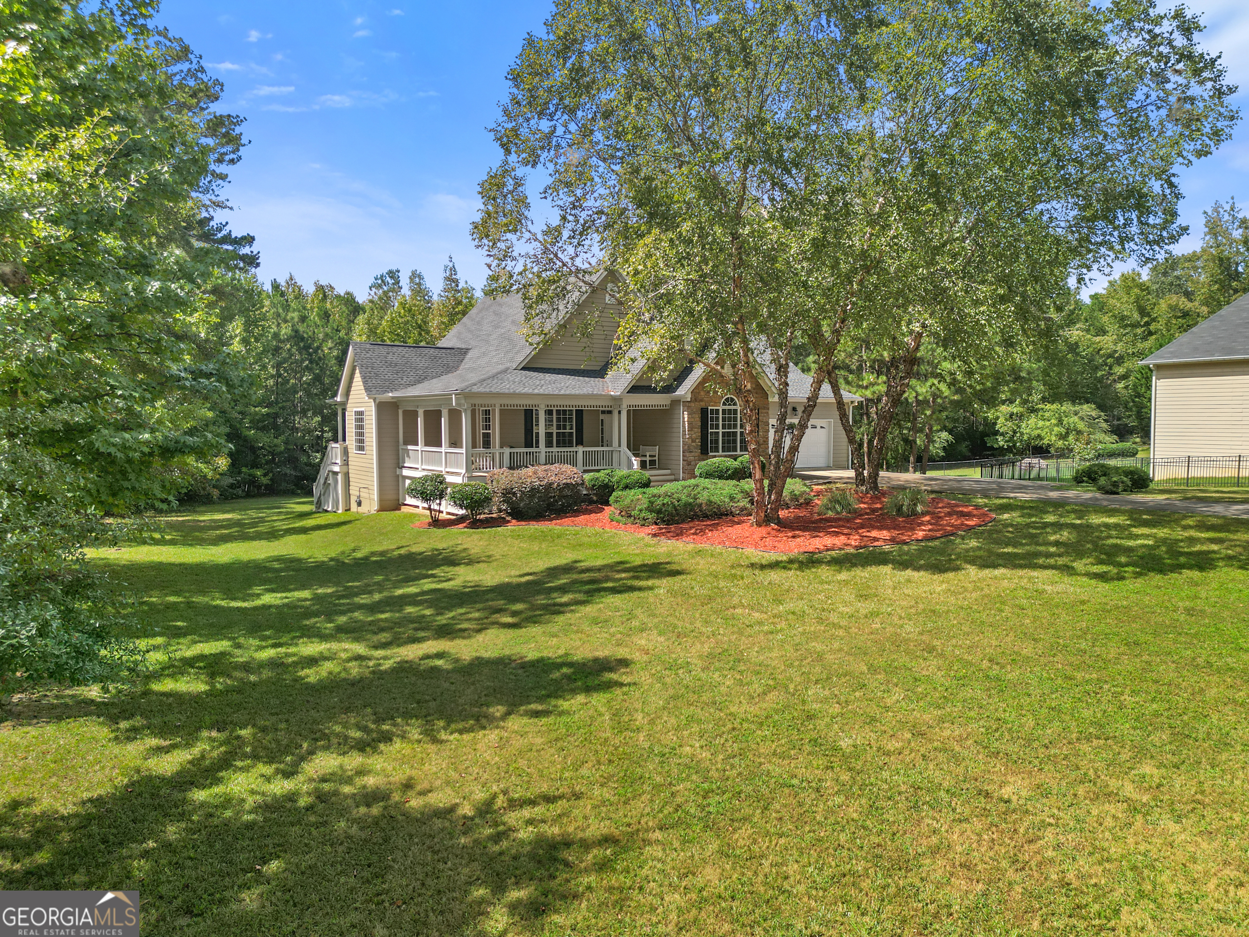 a house view with swimming pool and trees