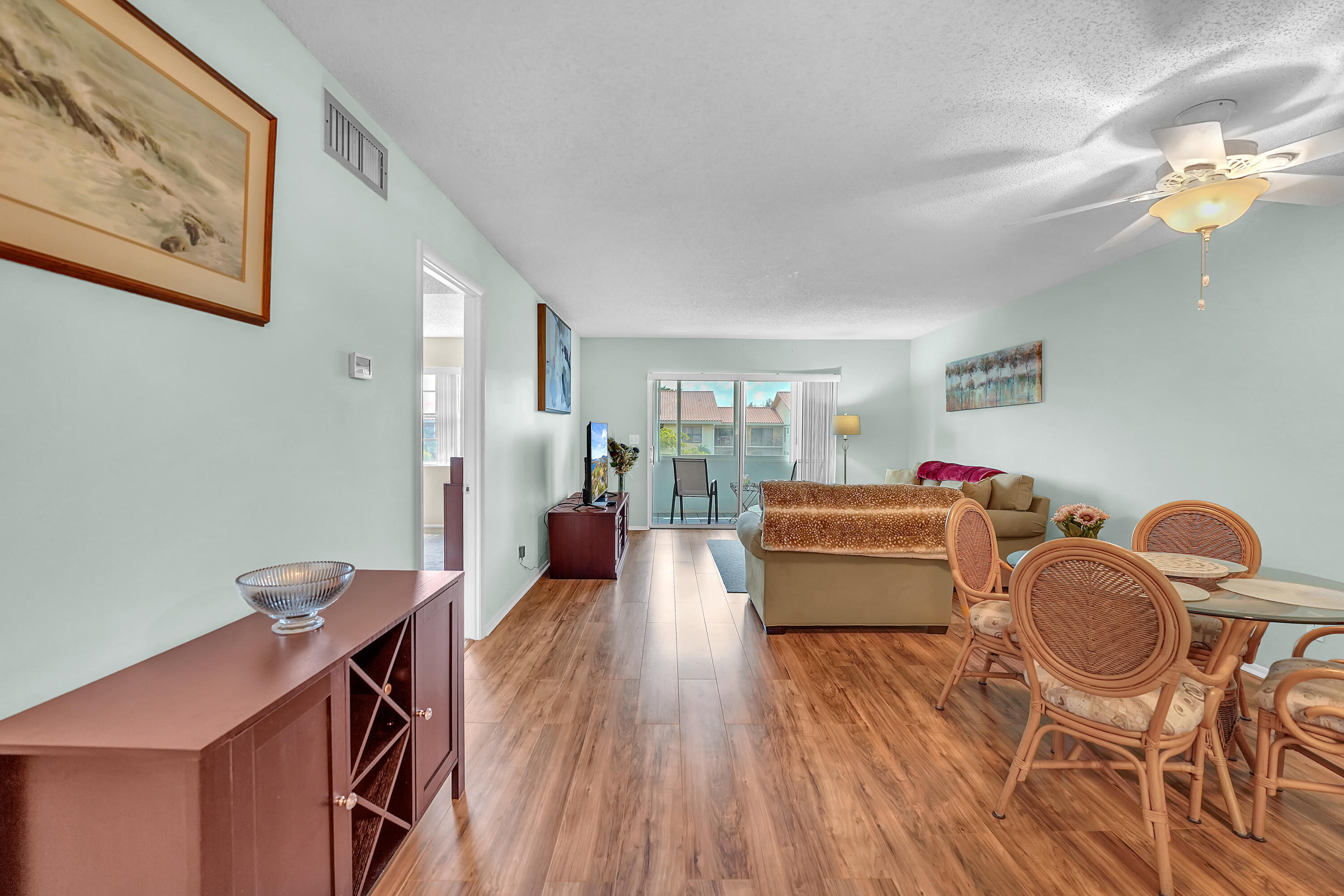 a dining room with furniture and wooden floor