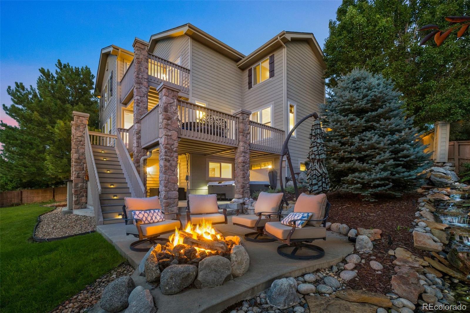 a view of a house with backyard water fountain and sitting area