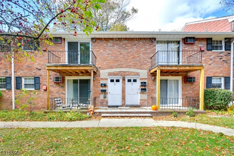 front view of a brick house with a yard