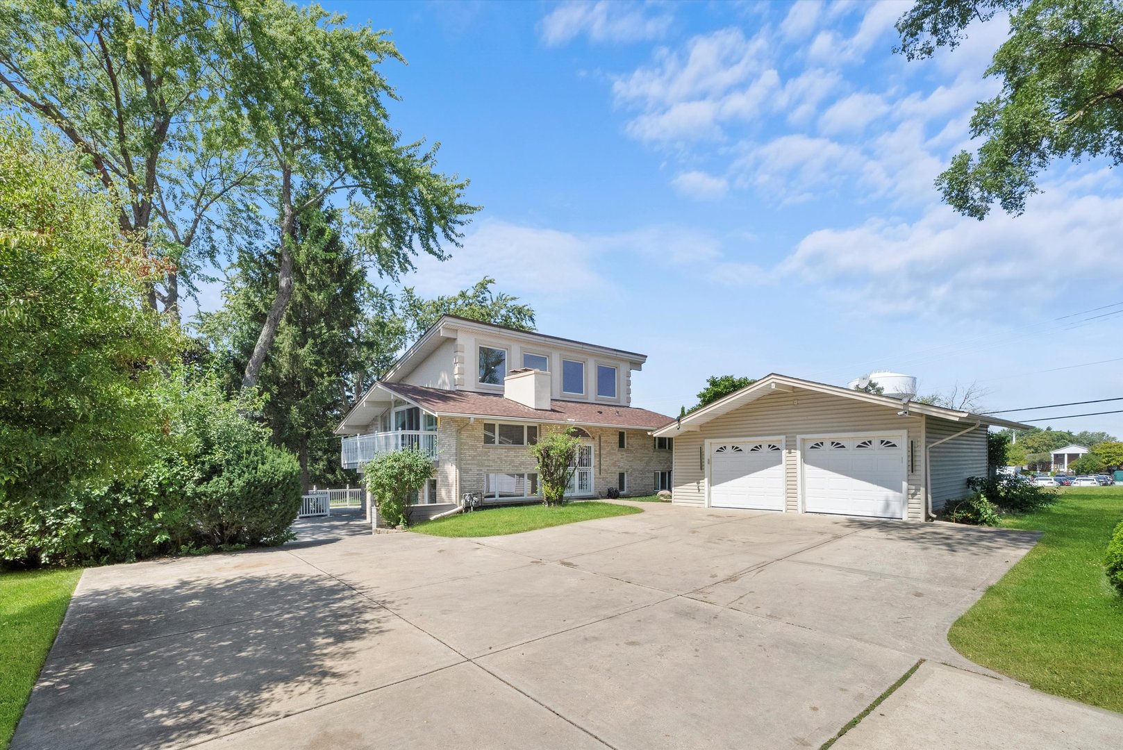 a front view of a house with a yard and a garage