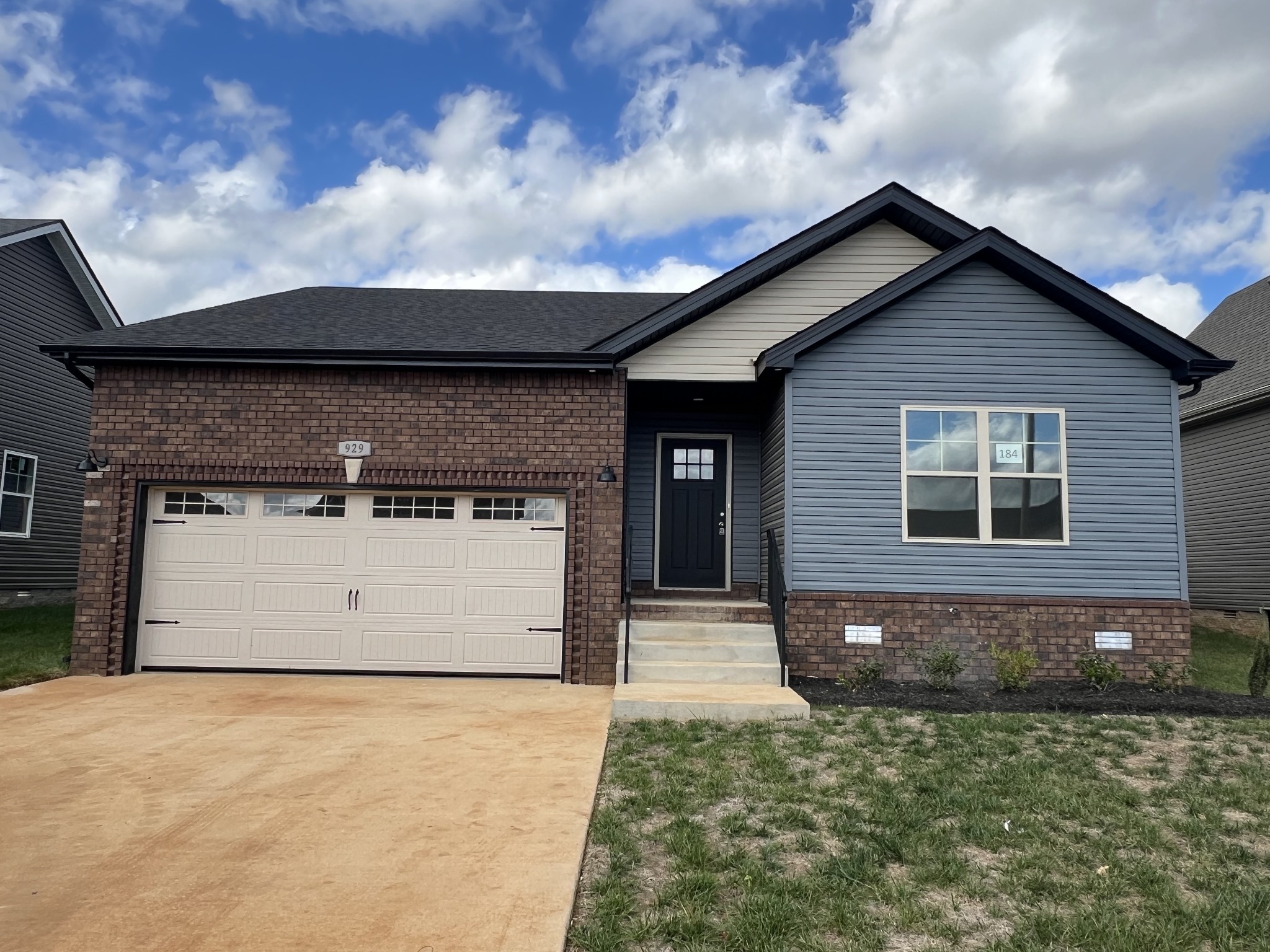 a front view of a house with a yard and garage