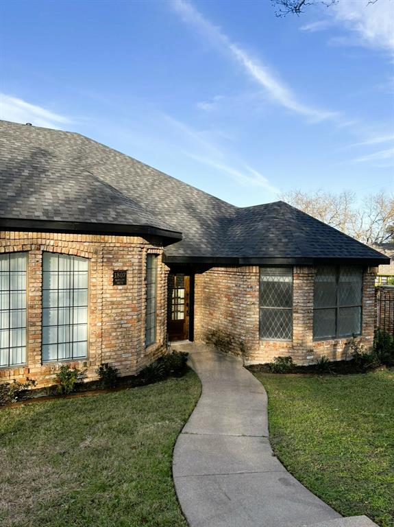 a front view of a house with a garden and porch