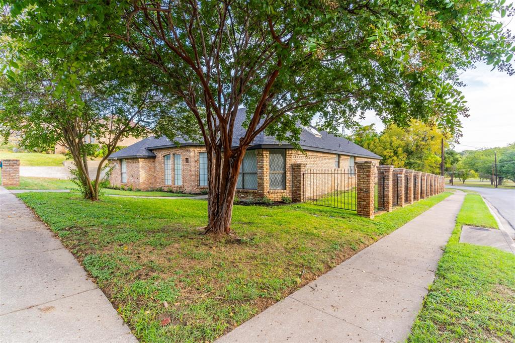 a view of a house with a yard and tree s