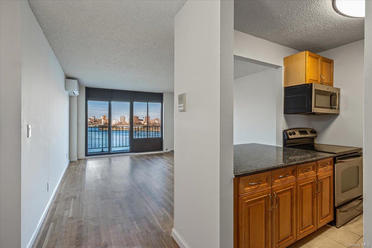 a kitchen with granite countertop a sink and a stove top oven