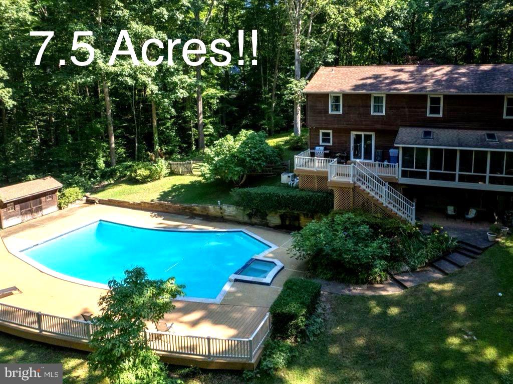 a view of a house with pool and chairs