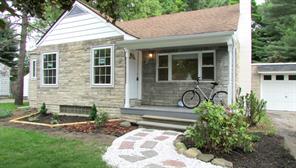 a front view of a house with yard outdoor seating and green space