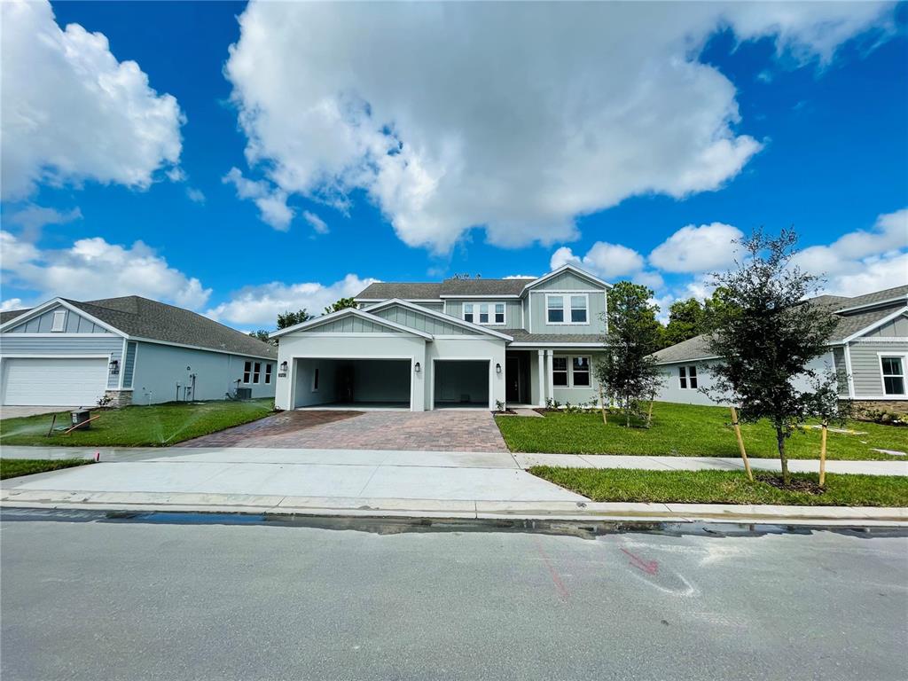 a front view of a house with a yard and garage