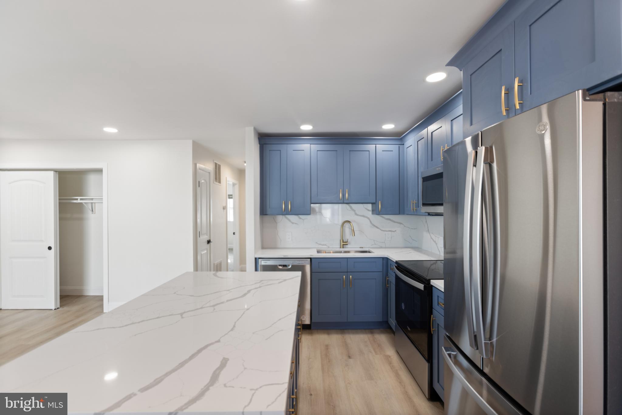 a kitchen with stainless steel appliances a refrigerator and a sink