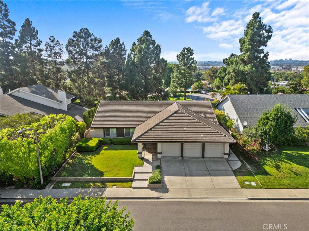 an aerial view of a house with swimming pool and patio