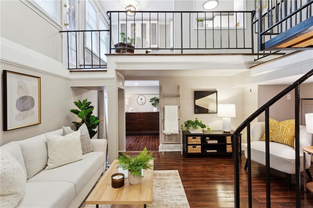 a living room with furniture and wooden floor