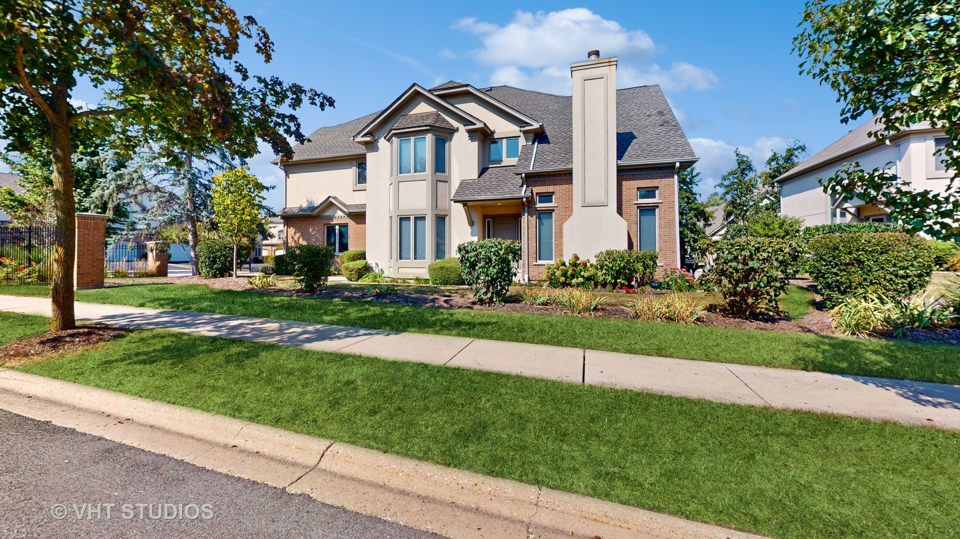 a front view of house with yard and green space