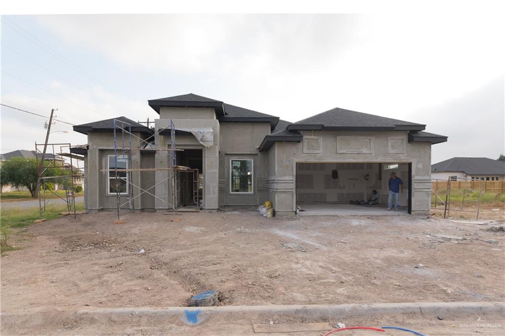 a view of a house with a yard and garage