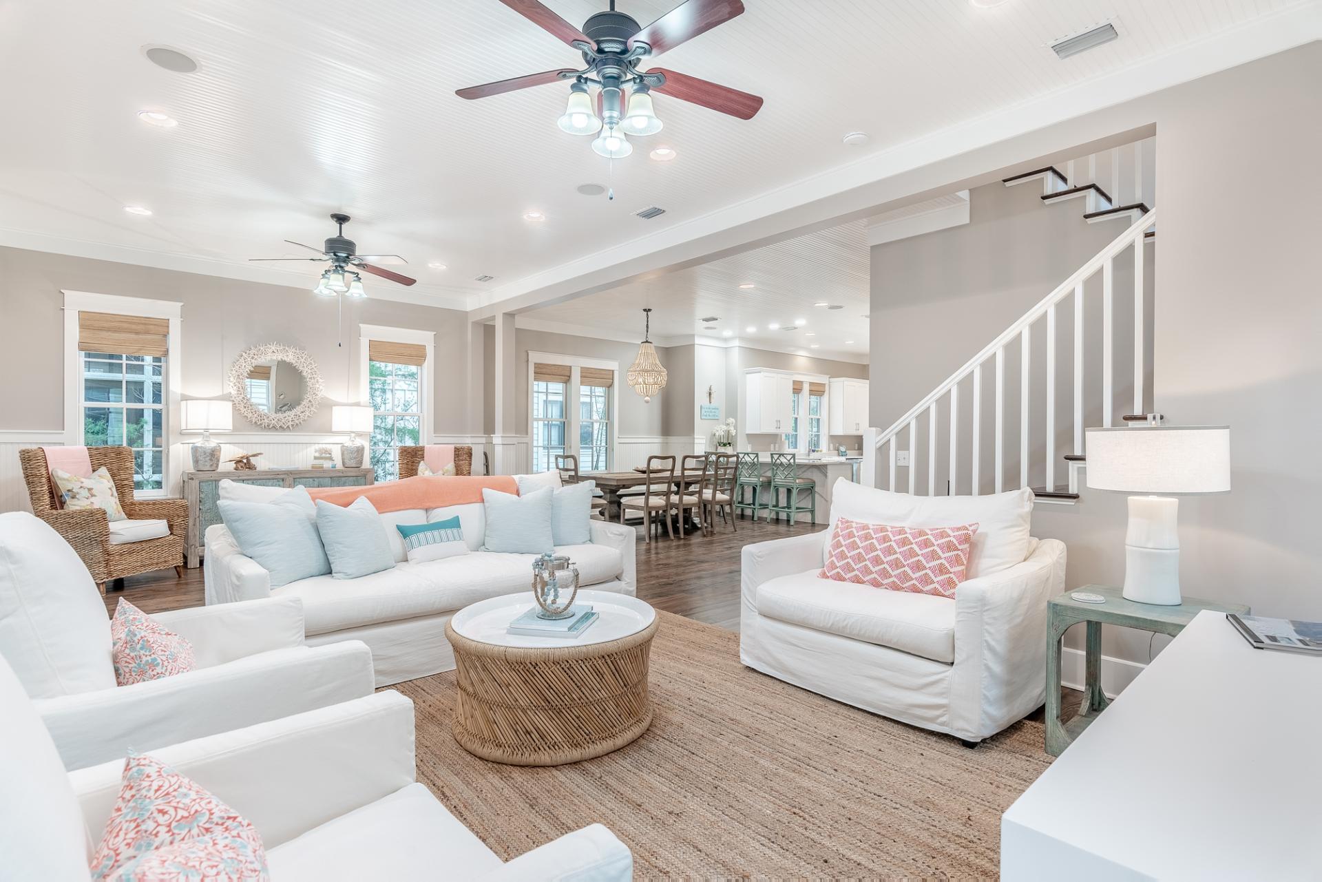 a living room with furniture and a chandelier