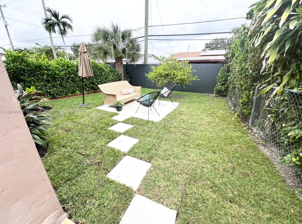 a view of a backyard with sitting area