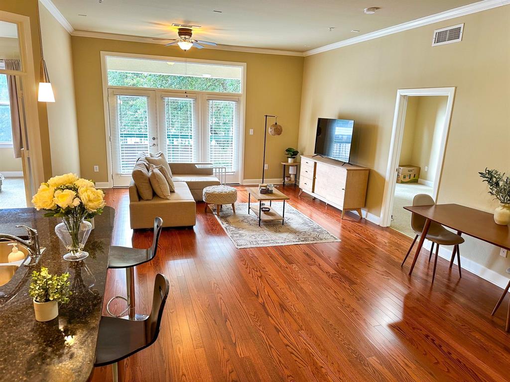 a living room with furniture and wooden floor