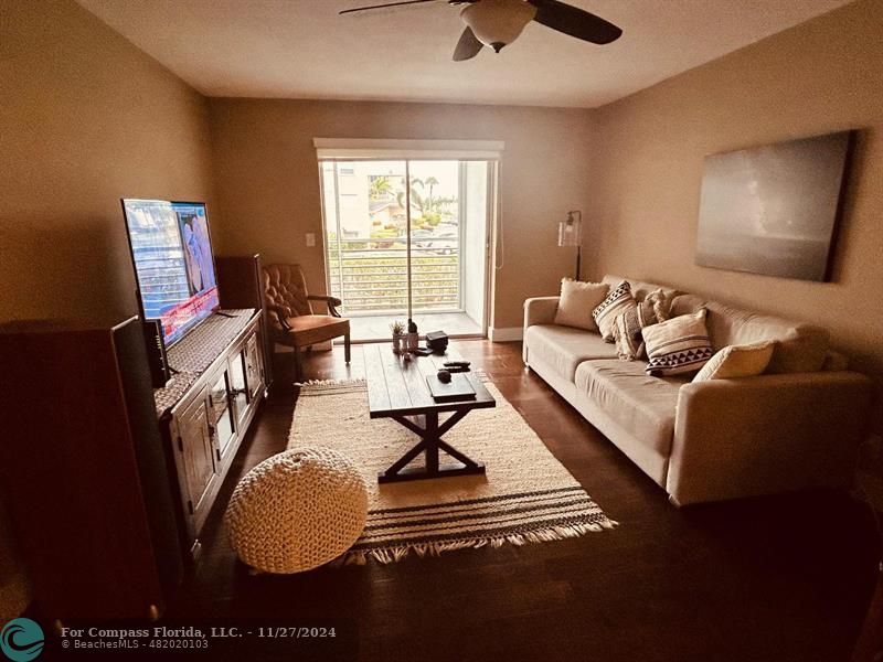 a living room with furniture a rug and a window