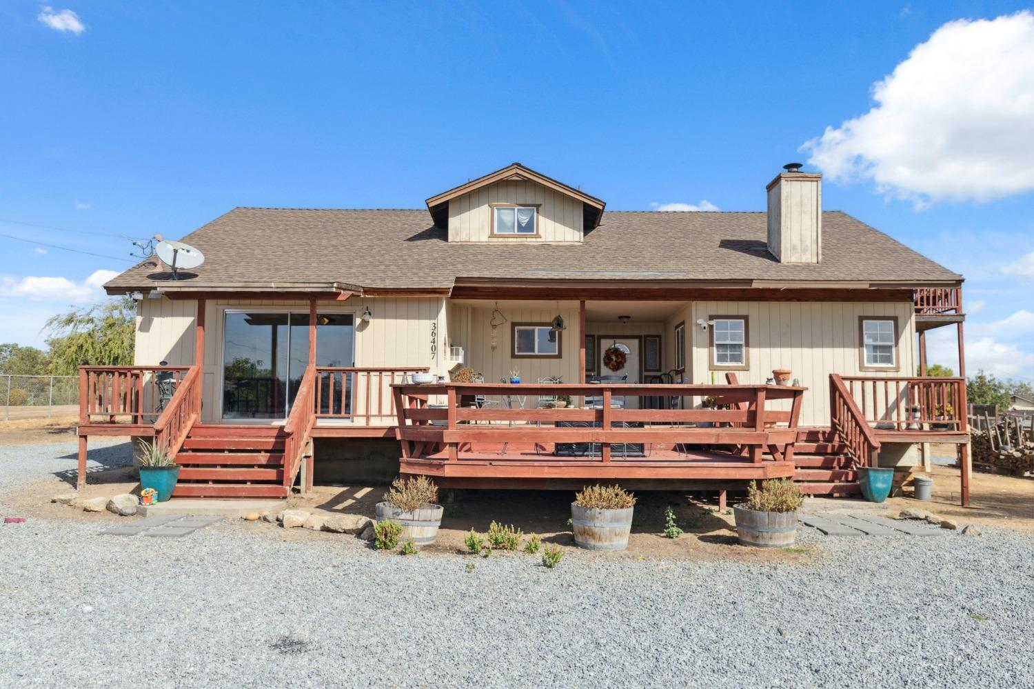 a view of a house with roof deck and furniture