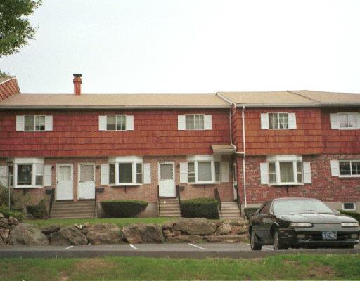 a car parked in front of a brick house