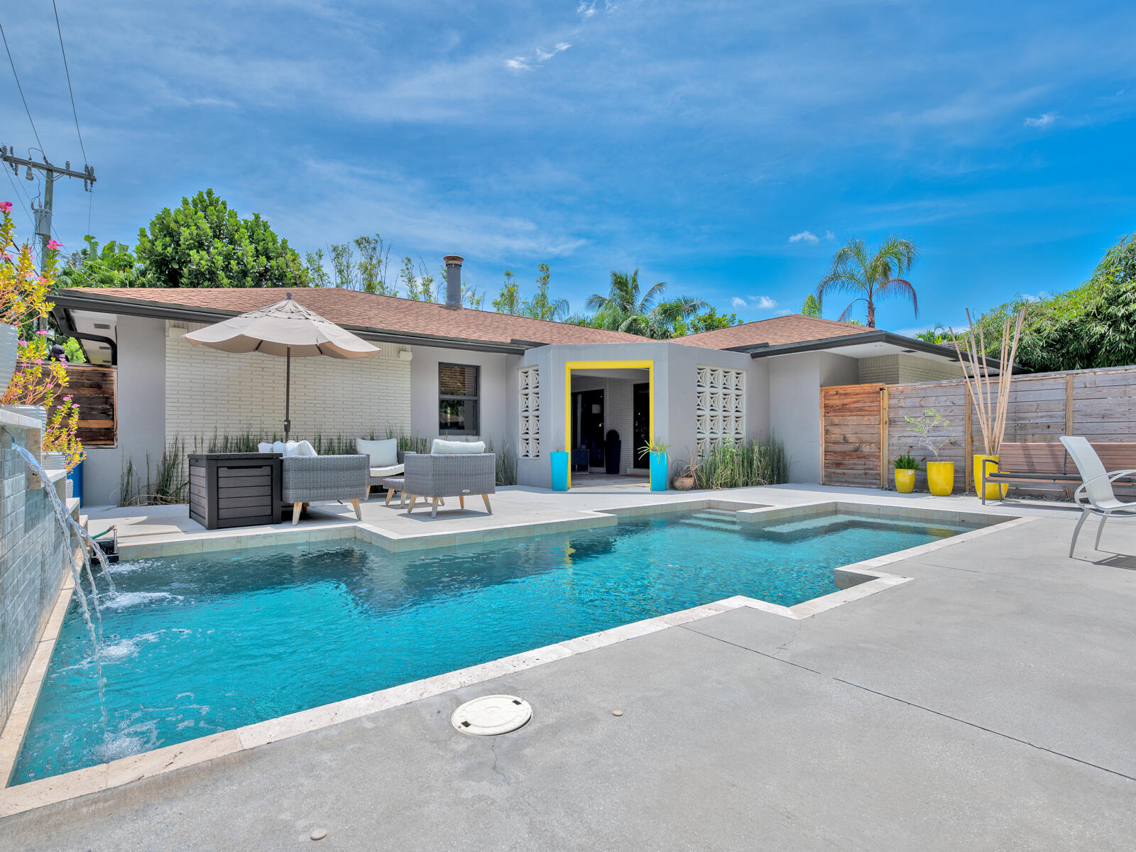 a view of a house with backyard sitting area and garden