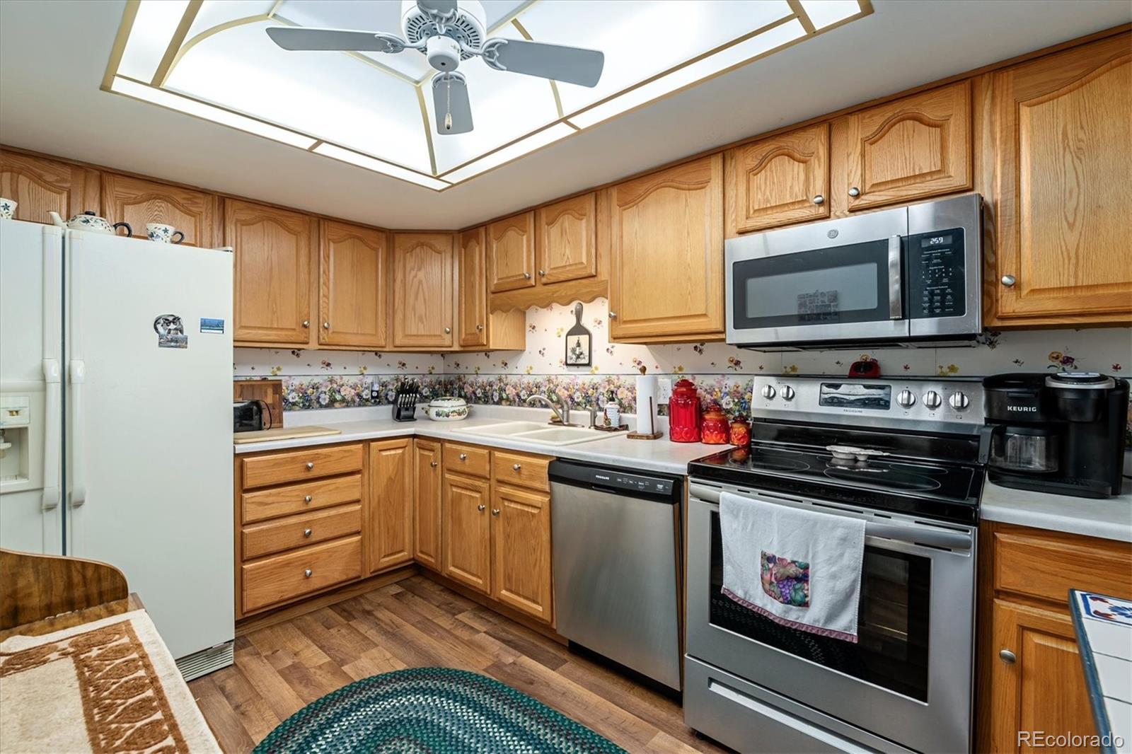 a kitchen with stainless steel appliances granite countertop a stove sink microwave and refrigerator