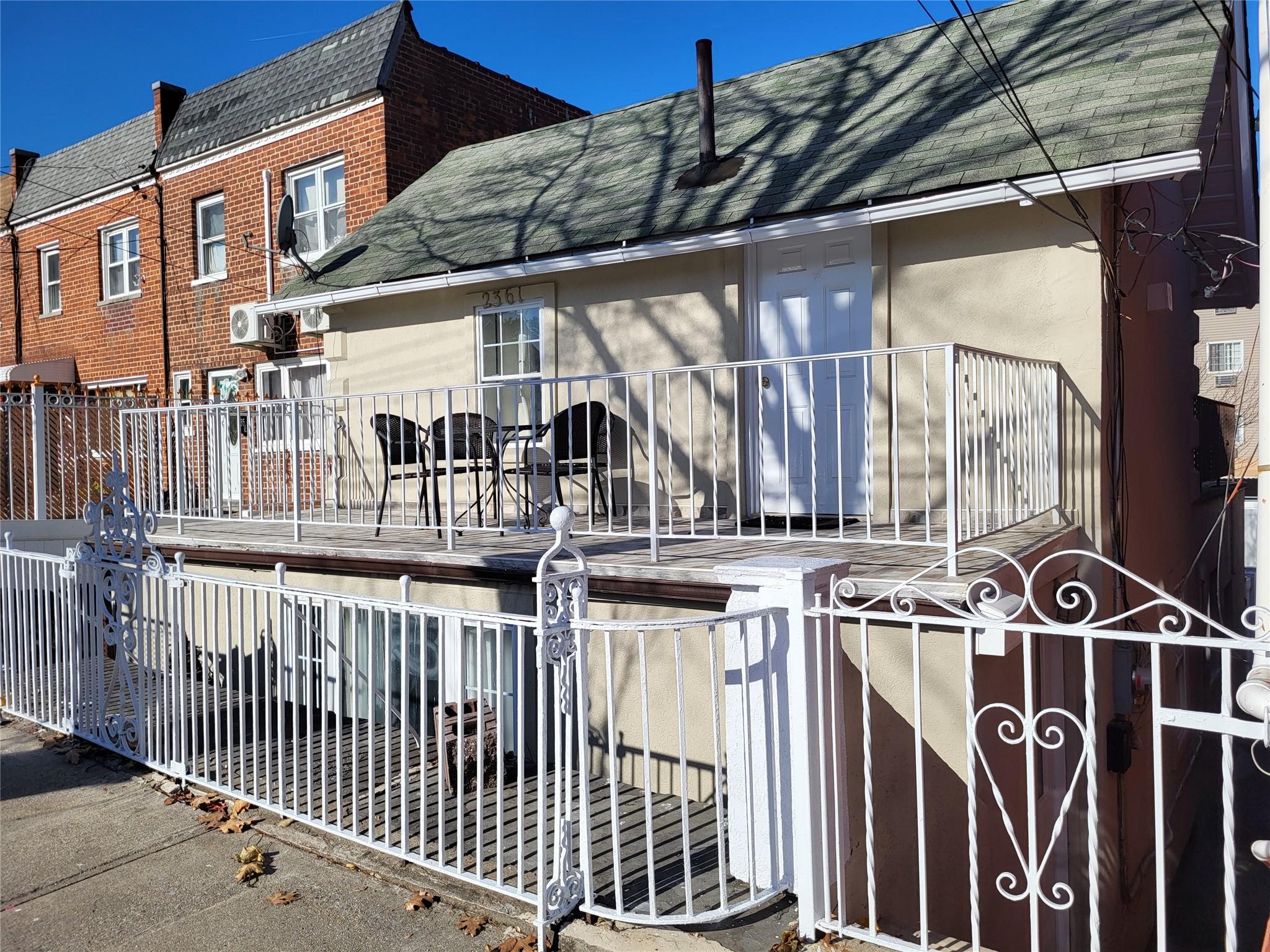 a view of a house with a wooden fence