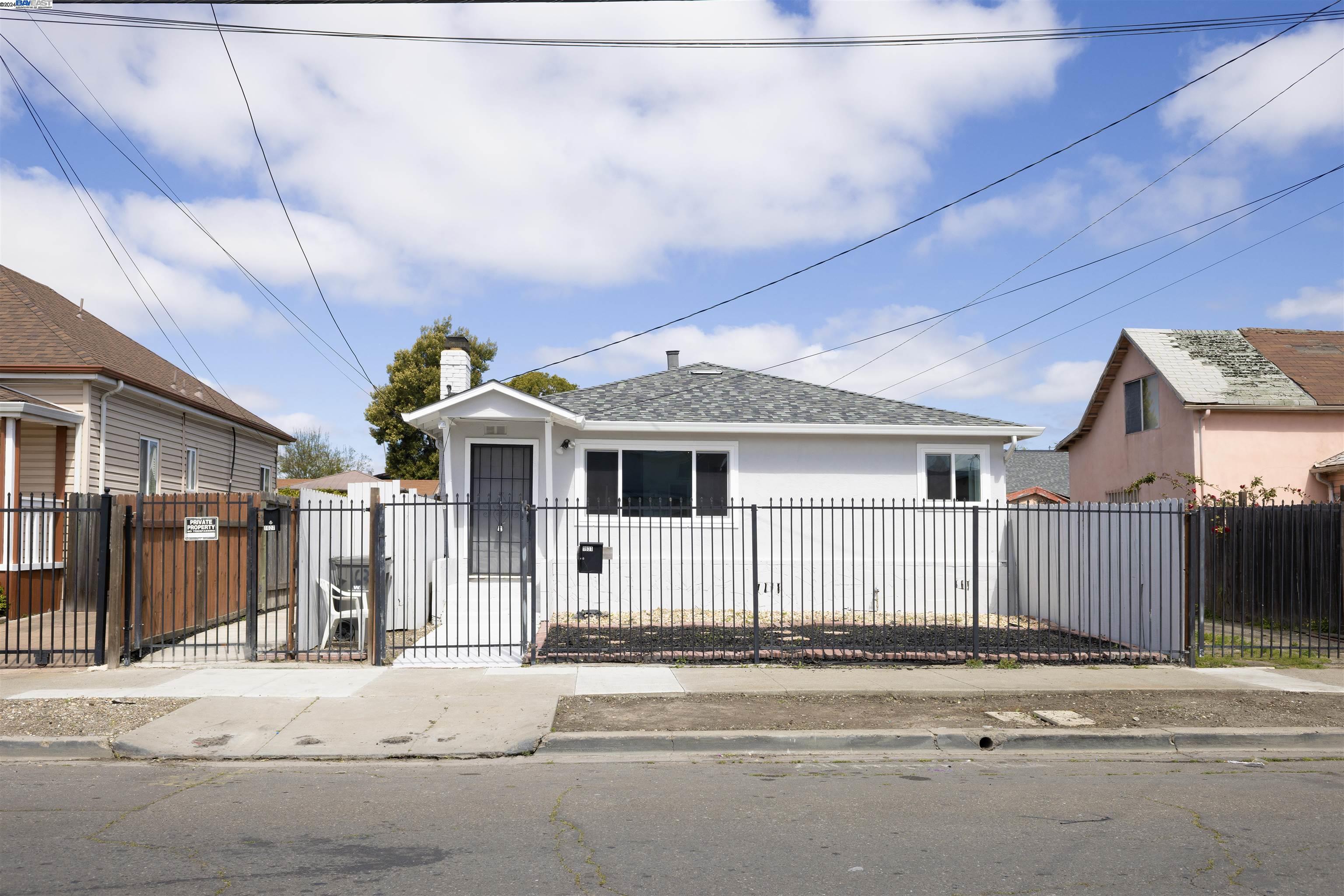 a front view of a house with a road