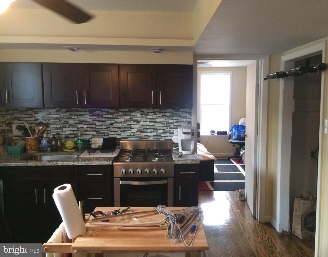 a kitchen with a stove and a refrigerator