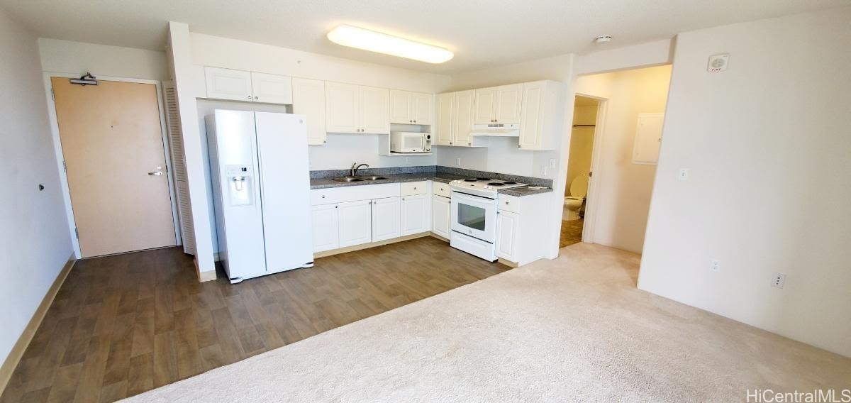 a kitchen with stainless steel appliances a refrigerator and a stove top oven