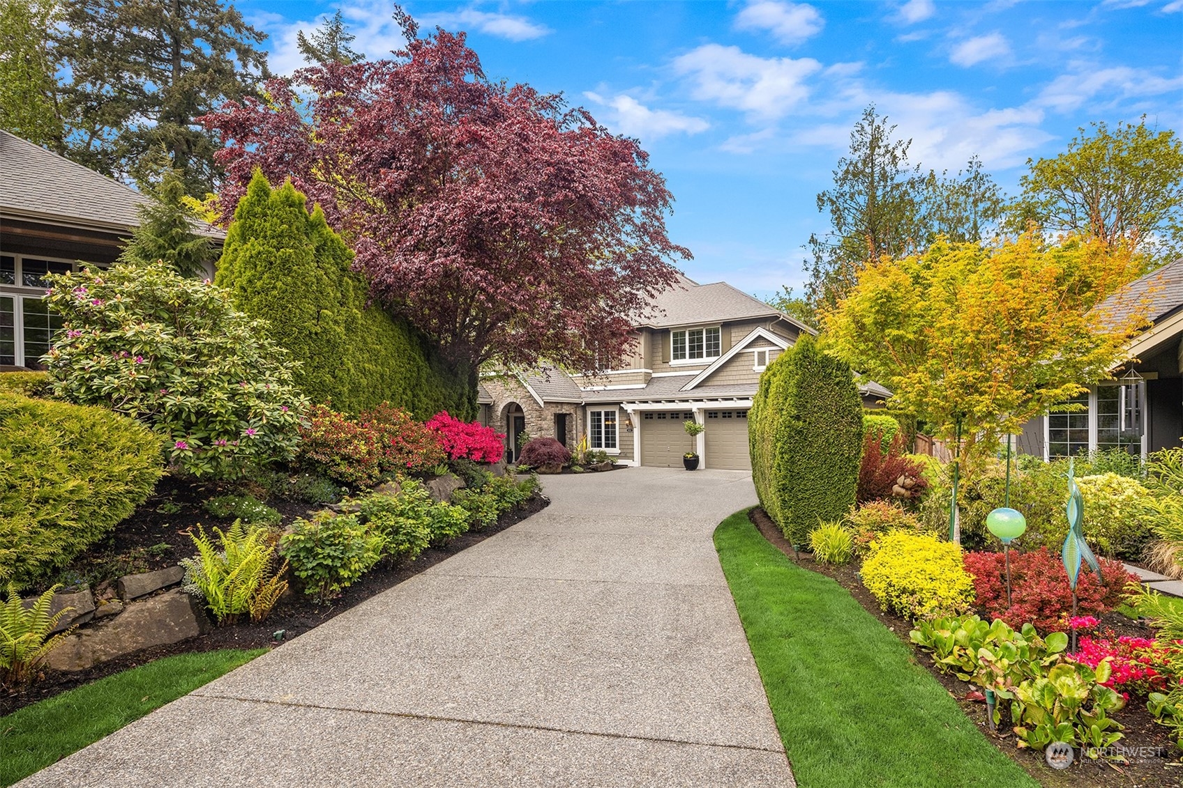 a front view of a house with a yard and fountain