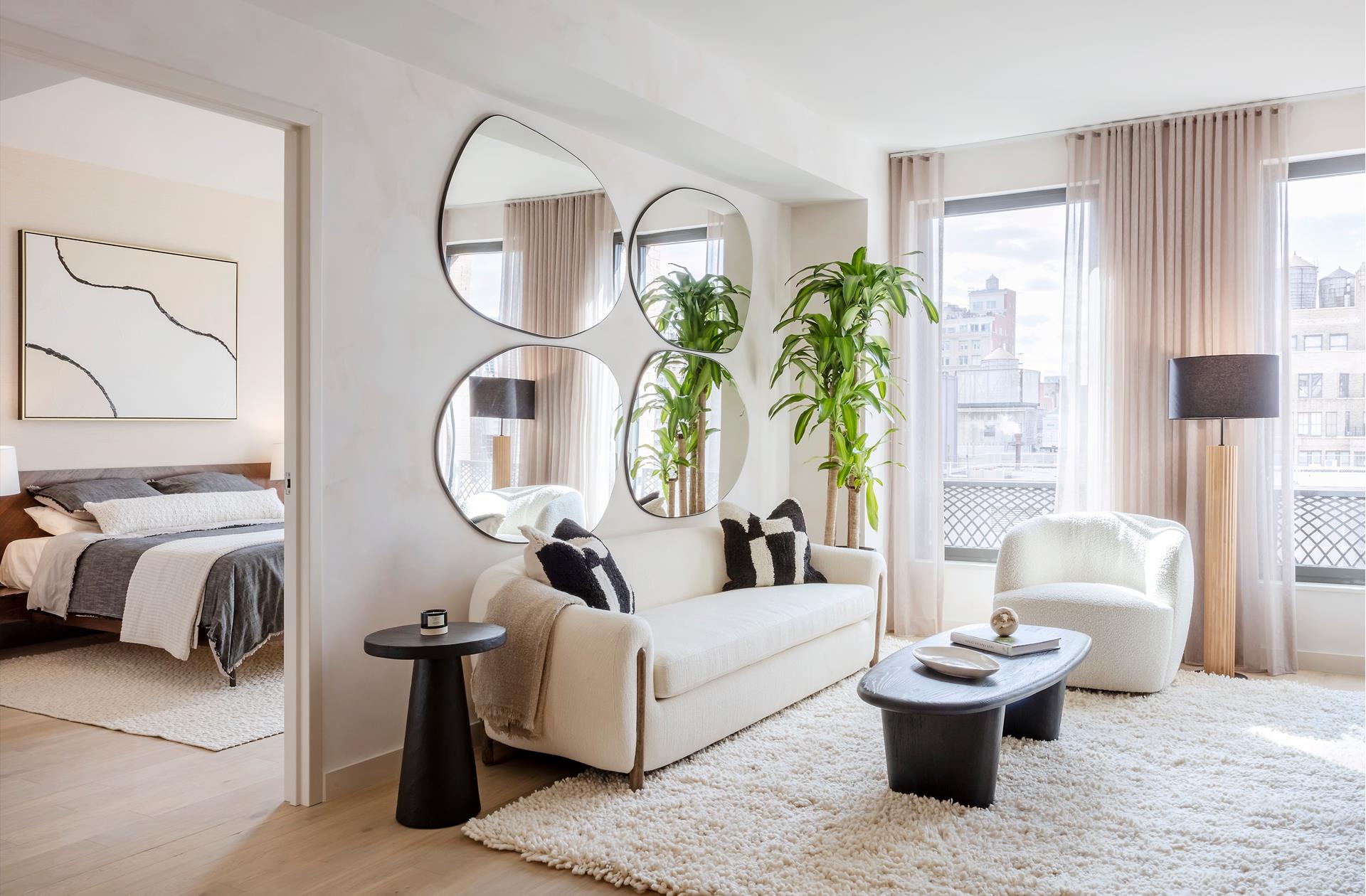 a living room with furniture a lamp and a potted plant