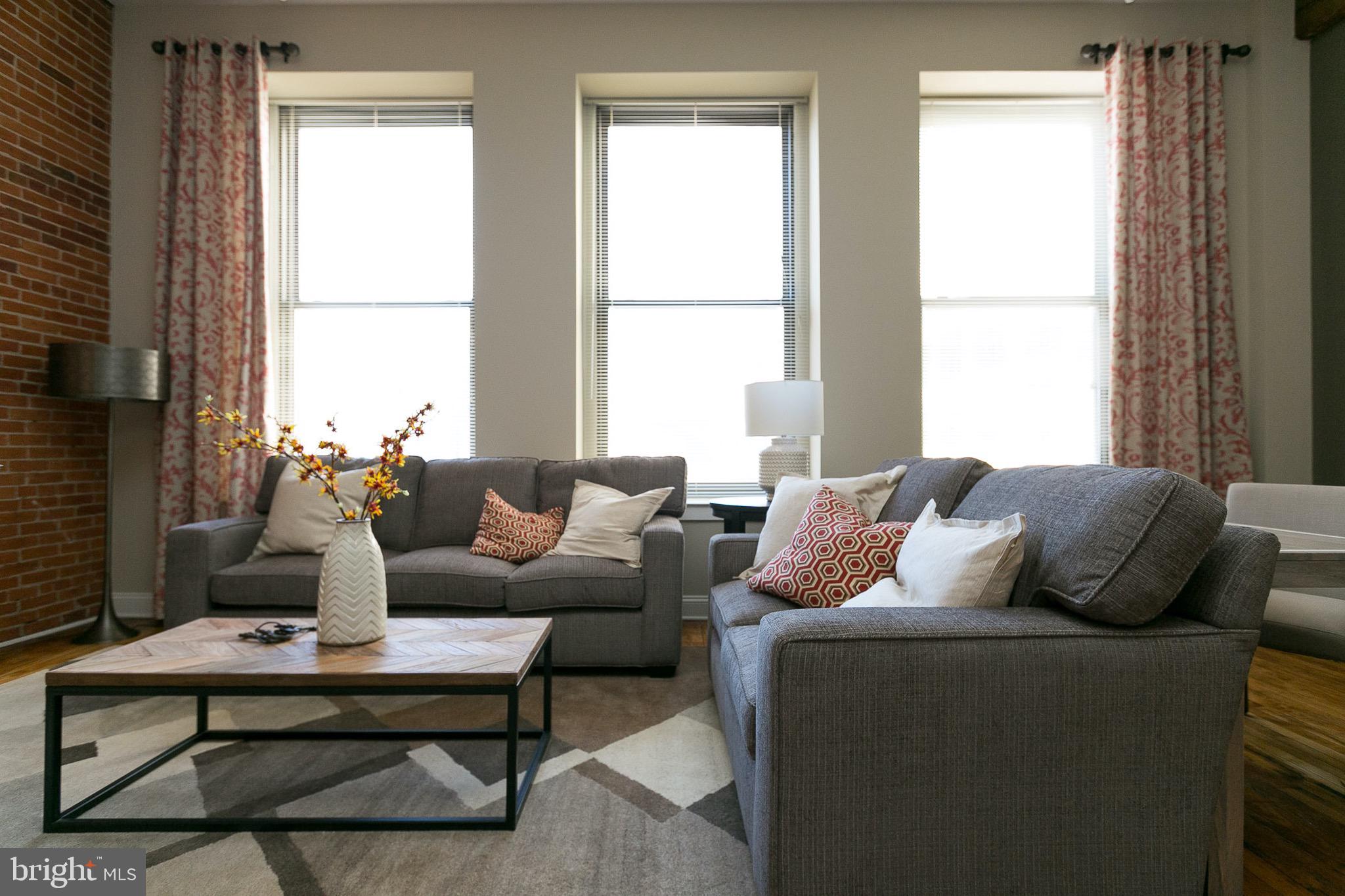 a living room with furniture and a window