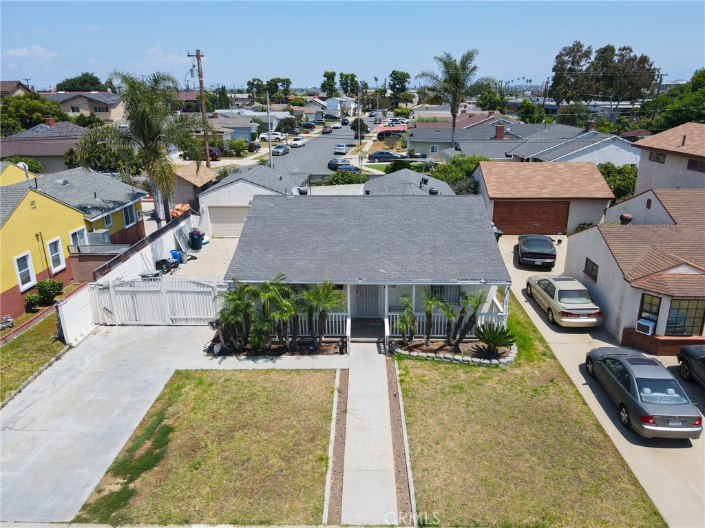 an aerial view of residential houses with outdoor space and swimming pool