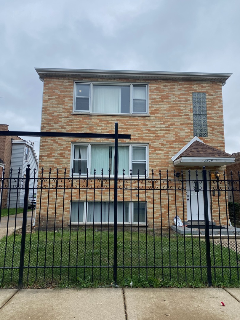 a view of a brick house with many windows