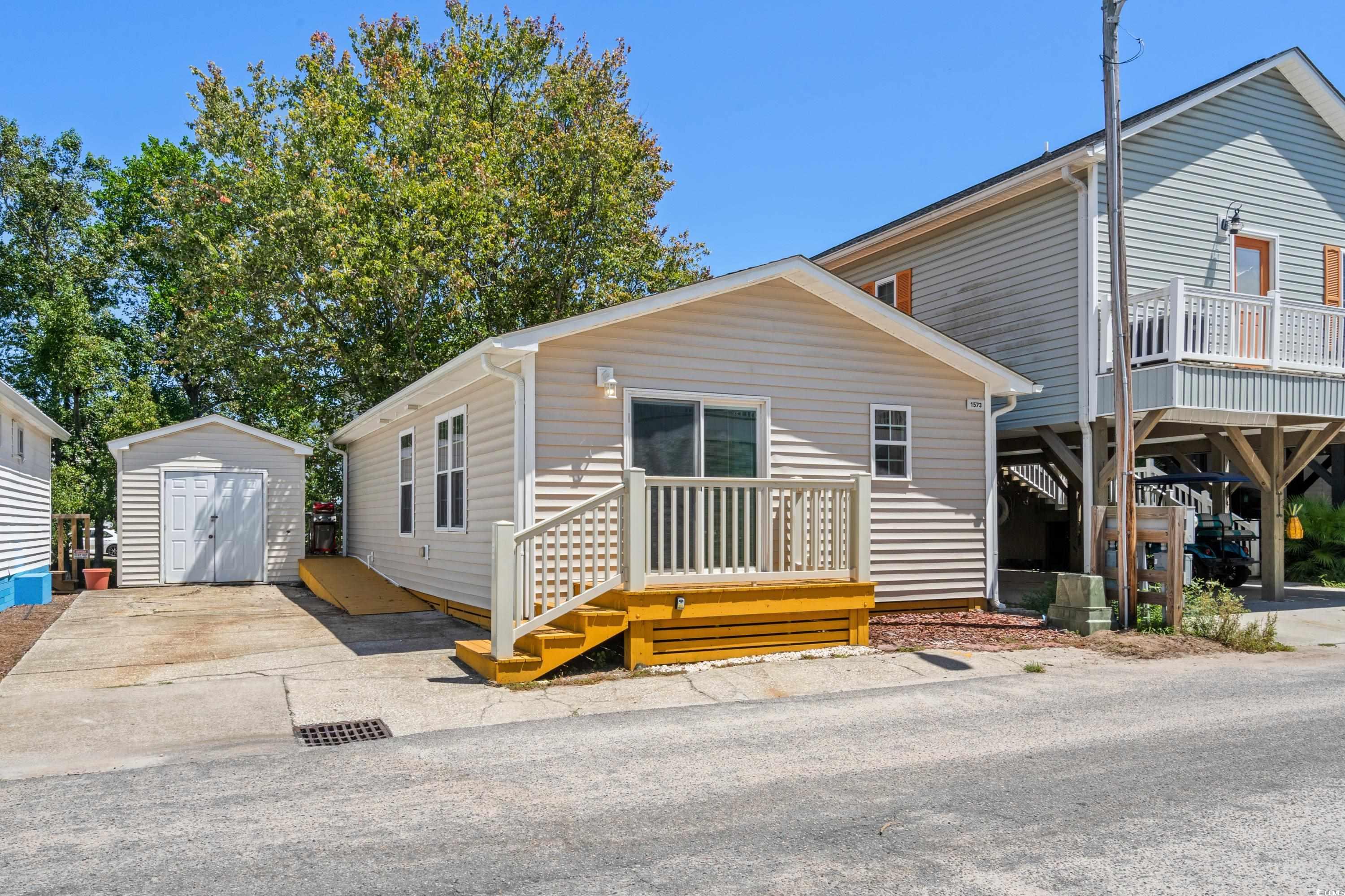 View of front of house with a storage unit