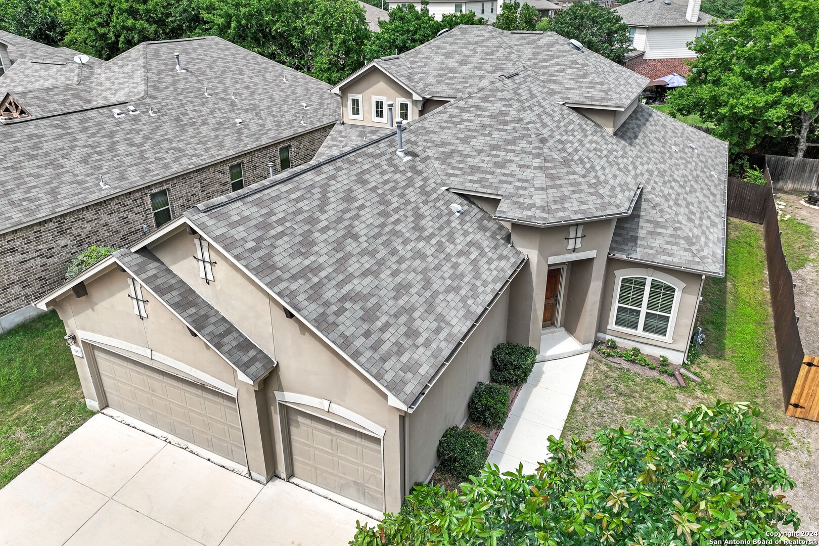 an aerial view of a house with a yard and potted plants