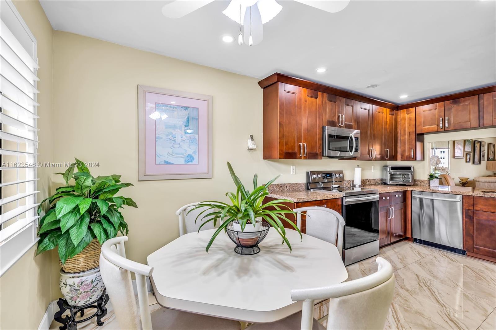 SPACIOUS UPDATED KITCHEN WITH BREAKFAST AREA, PLANTATION SHUTTERS INTERIOR WINDOW TREATMENT