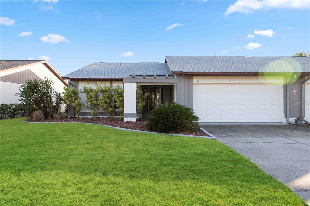 a front view of a house with a yard and garage