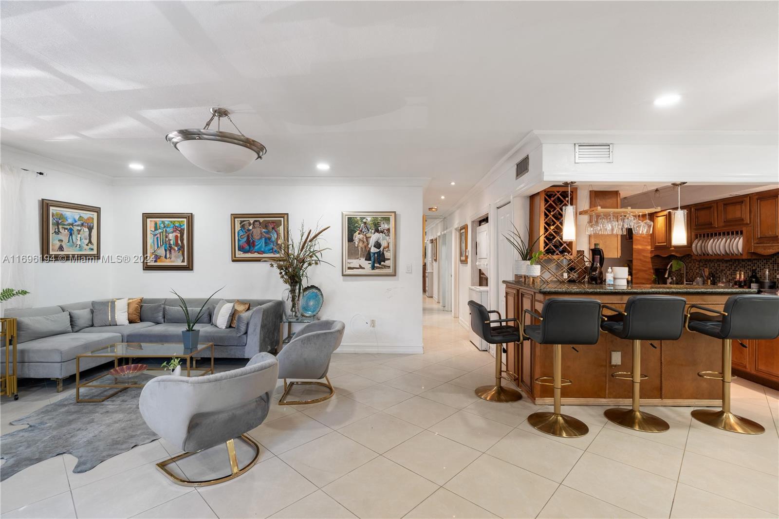 a living room with couches and kitchen view