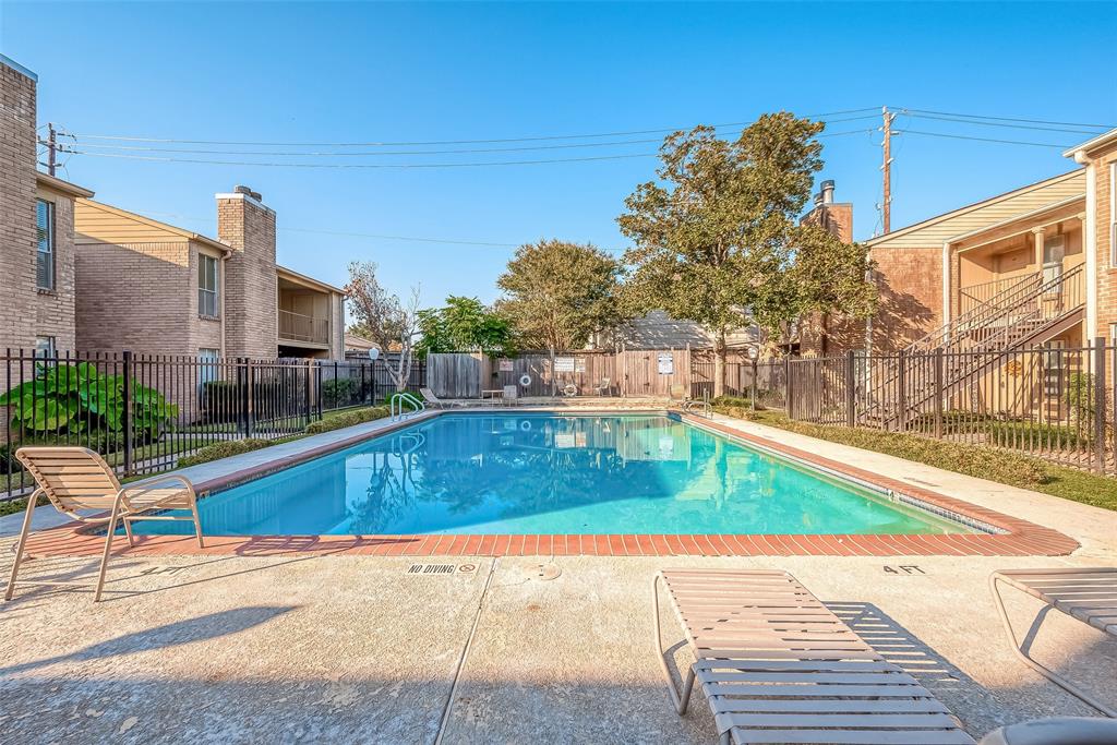 a view of a swimming pool with a lounge chairs